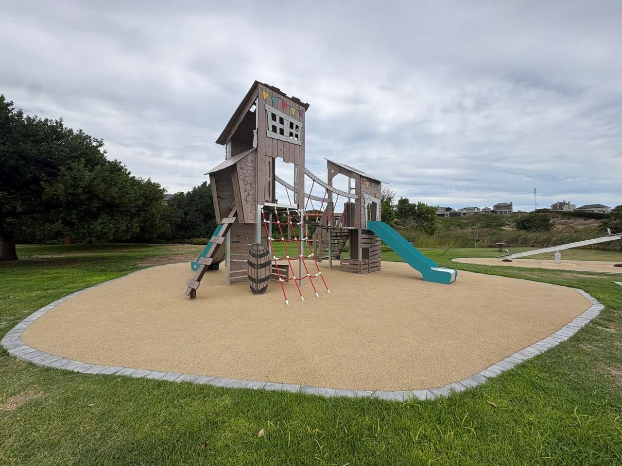 Pirate-ship play structure on wet-pour surfacing