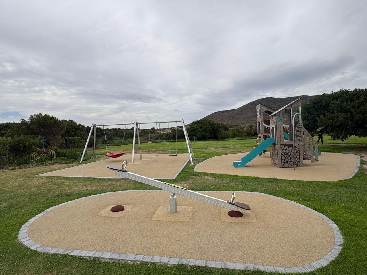 Swings and seesaw on rubber safety surfacing