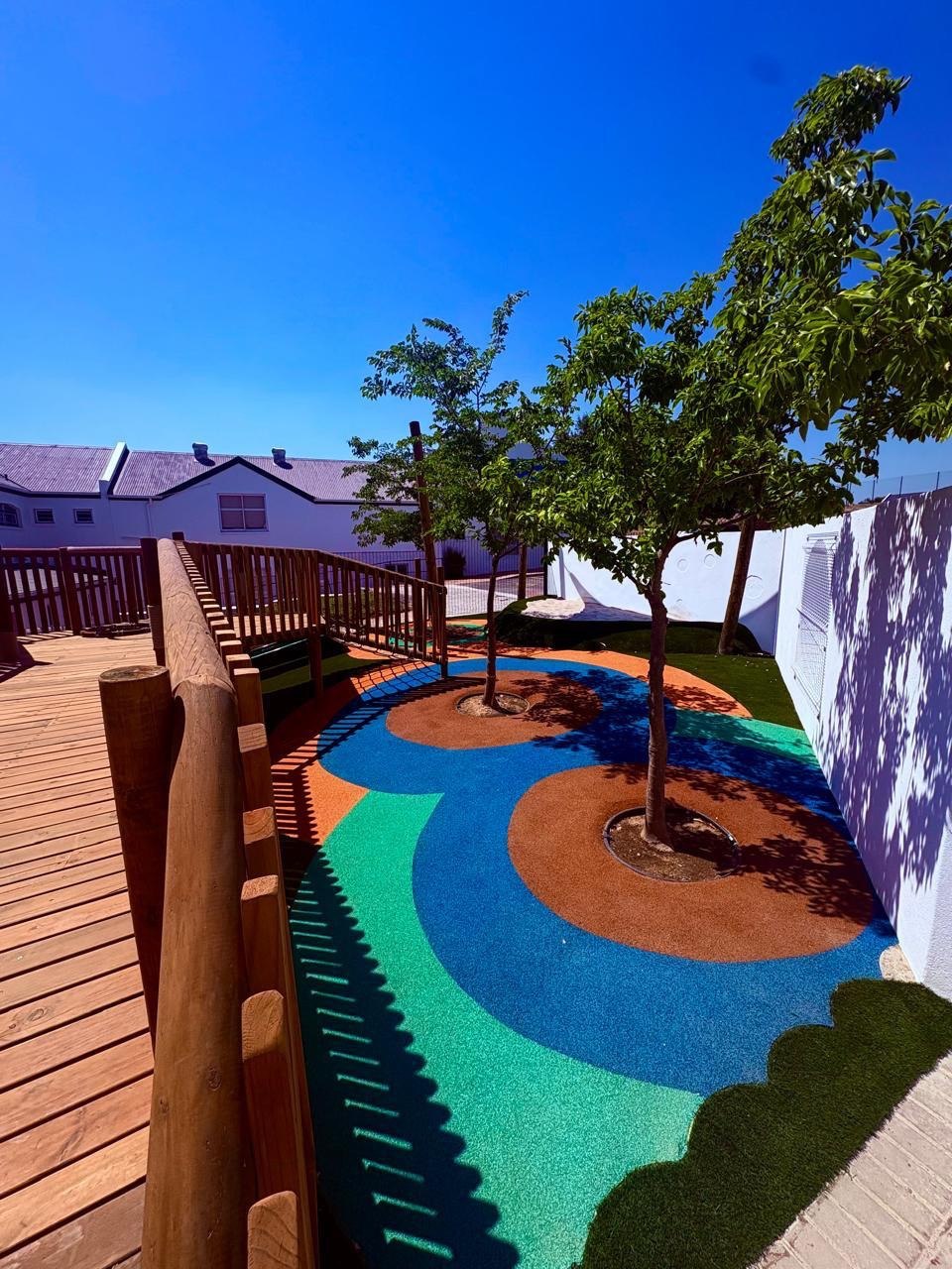 Wet-pour rubber surfacing detail around tree